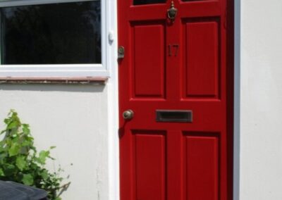 Transformation of front door achieved through exterior painting - After 1
